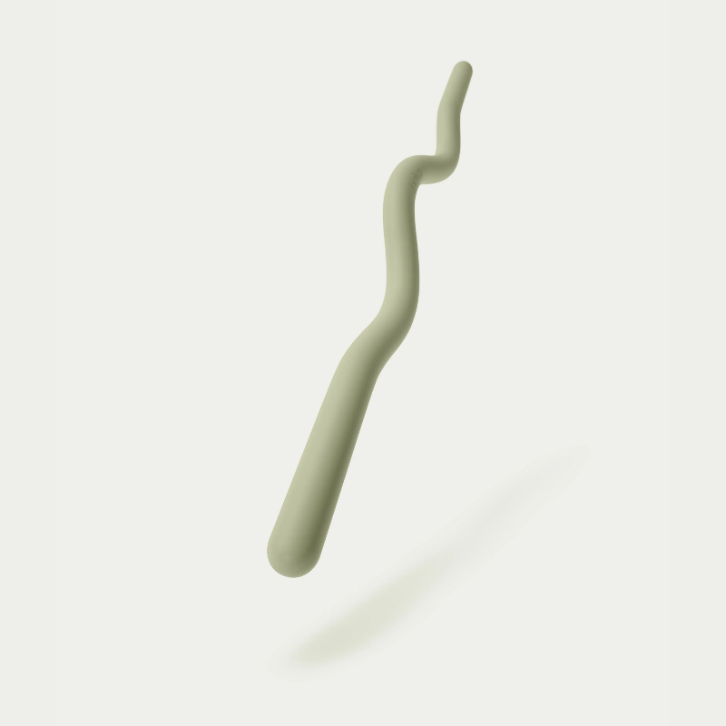 A sage green exercise band or loop, sculpted and ergonomic in design, likely made of a soft silicone wrap around a steel core.