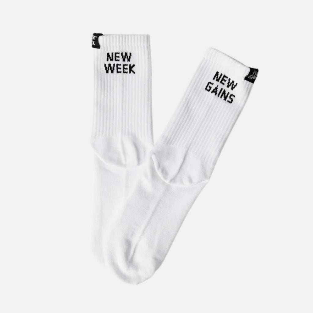 White socks with 'New Week' and 'New Gains' text on a white background
