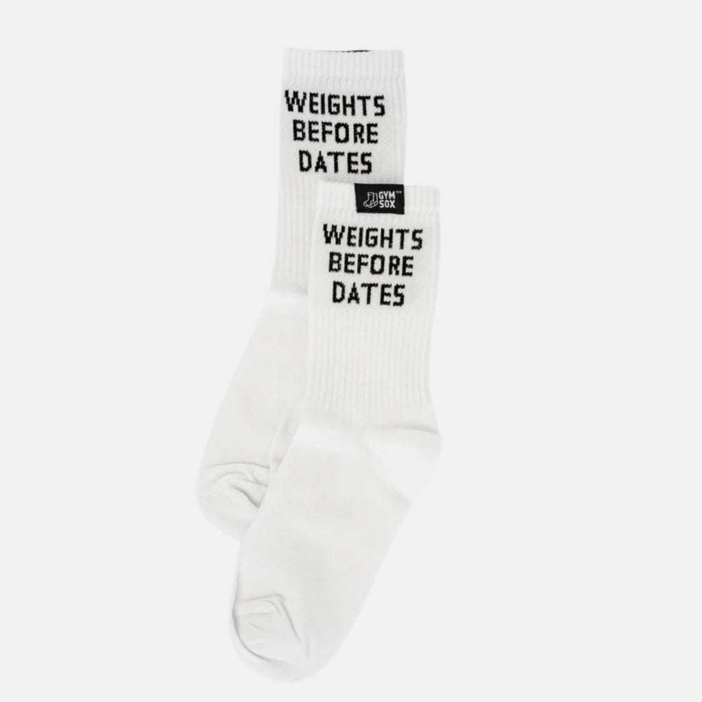 A pair of white crew socks with black text reading 'WEIGHTS BEFORE DATES' and a small black brand tag near the cuff, shown on a light gray background.