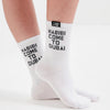White socks with 'Habibi Come to Dubai' text worn by a person on a white background