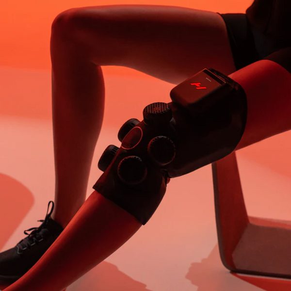 person using hyperice contrast knee hot and cold compression therapy to treat knee pain
