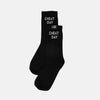 A pair of black crew socks with 'CHEAT DAY' printed in white text on the side, displayed against a light gray background.