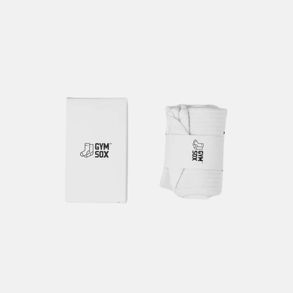 White gym socks with black 'GYM SOX' branding, shown folded flat and rolled with a matching white band on a light gray background.