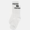 White socks with 'CONSISTENCY' text on a white background