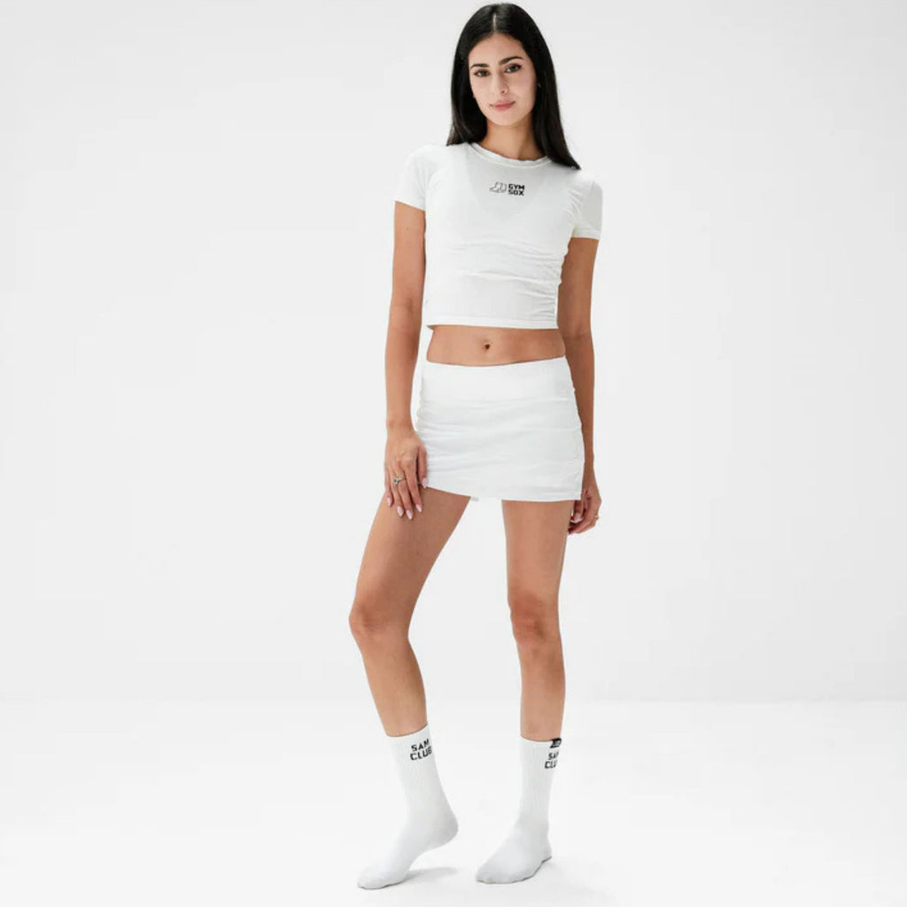 Woman wearing a white outfit with a logo on a white background