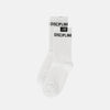 A pair of white crew socks with black text reading 'DISCIPLINE' on the cuffs, shown against a light gray background.
