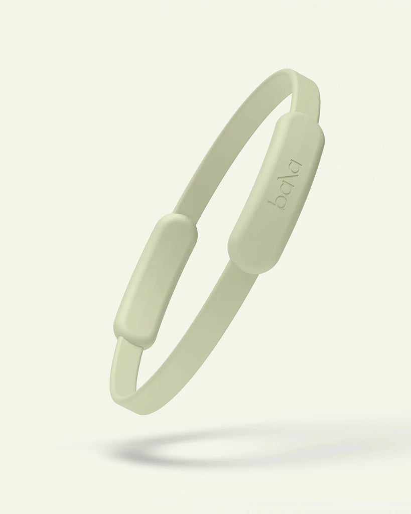 Light green silicone bala pilates circle on a white background