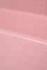 Close-up of a pink textured Bala Compact yoga mat surface with circular patterns