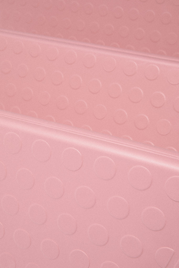 Close-up of a pink textured Bala Compact yoga mat surface with circular patterns