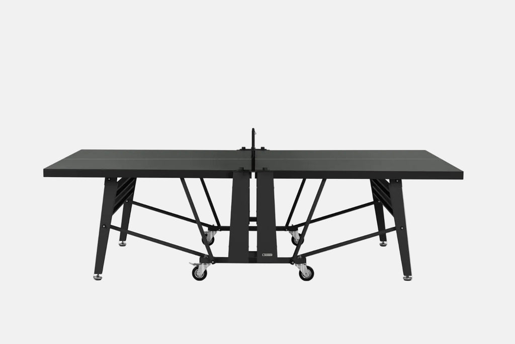 A black convertible ping-pong table with a wheeled base and central support frame, shown from the front on a white background.