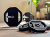 Barbell with weight plates on a wooden surface in a home setting