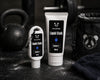 Two bottles of two pandas Liquid Blueberry Scented Chalk on a black surface with a kettlebell in the background.