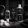 Two Pandas Liquid Rose Scented Chalk products on a black background with gym equipment.