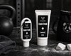 Two bottles of two pandas Liquid Unscented Chalk on a dark surface with gym equipment in the background.