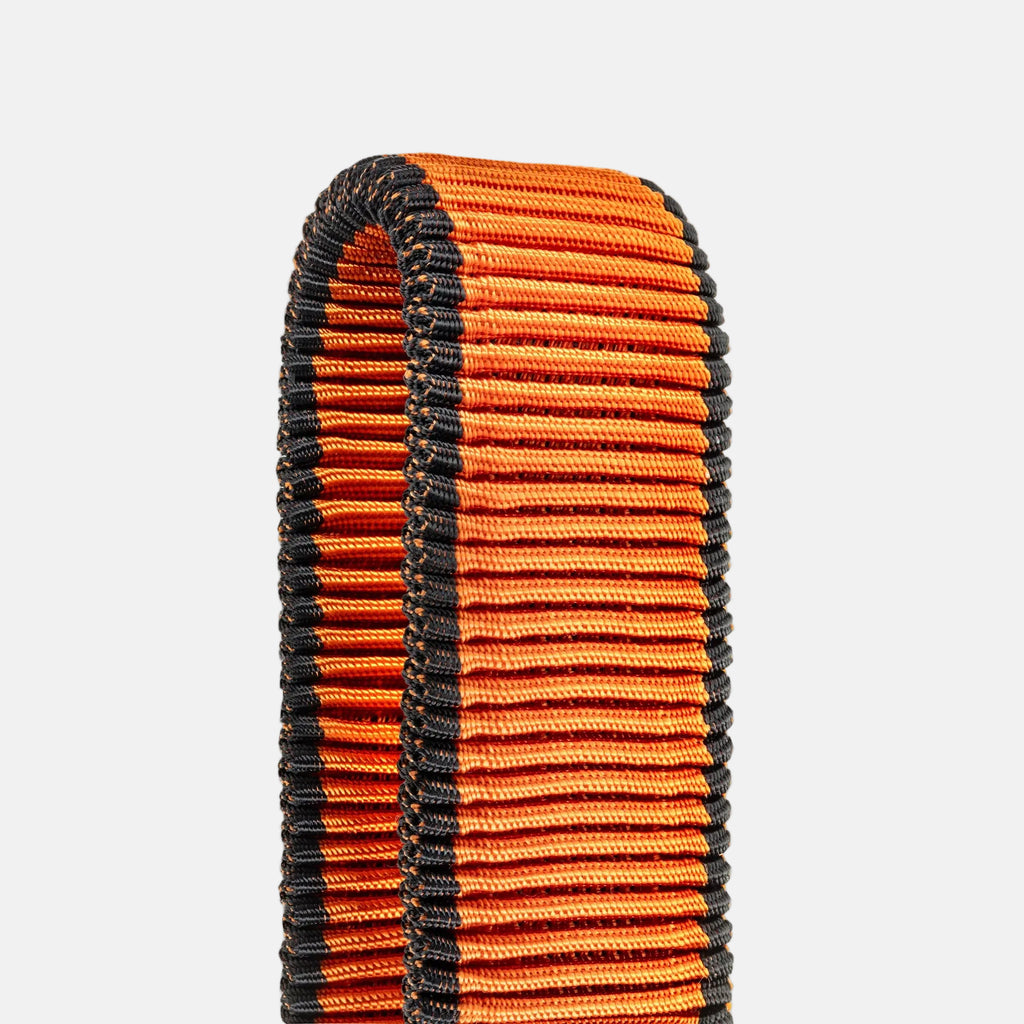 Detail photo of orange fitness band on a light gray background