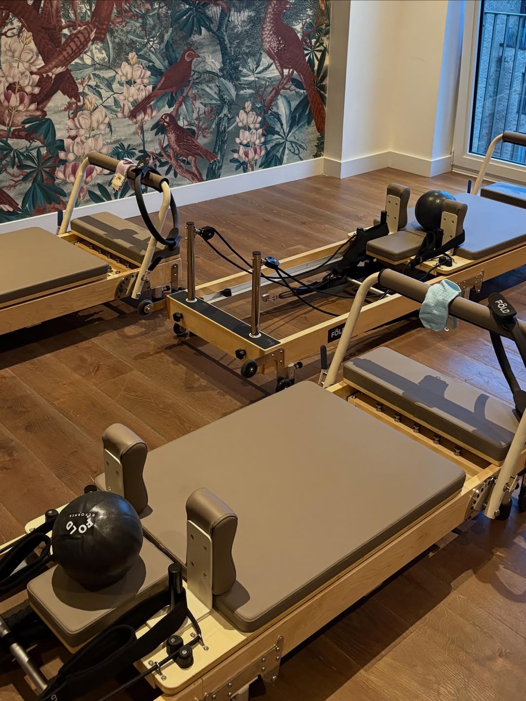 Mocha Fold reformer used in a pilates studio