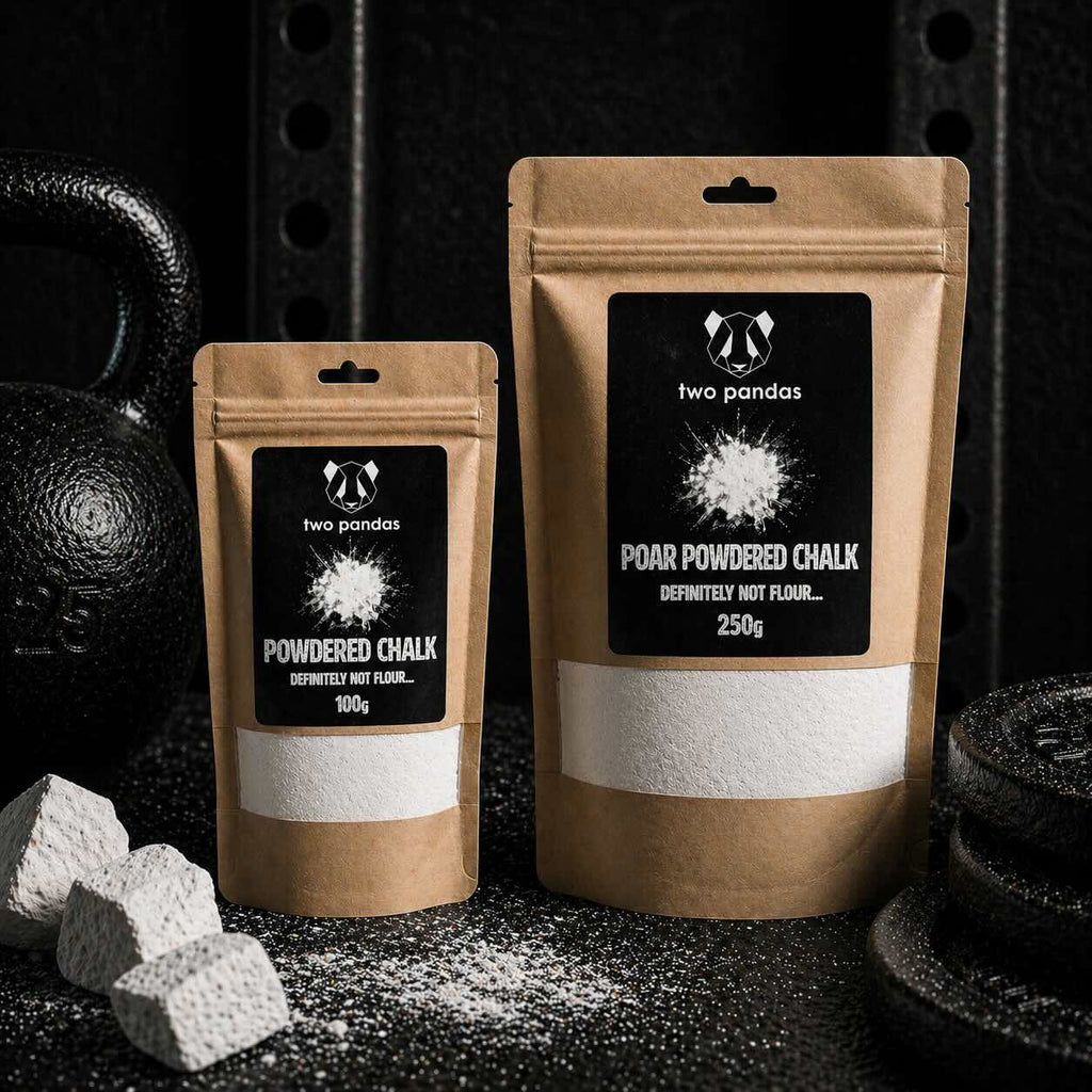 Two packages of 'two pandas' powdered chalk on a dark background with chalk blocks.