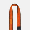 Detail image of orange and black resistance band on a light gray background