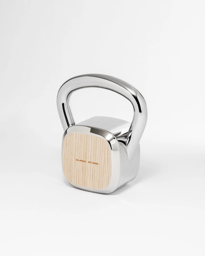 Alama Studio kettlebell striped white with polished metal on grey background