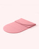 Pink colored semi-folded Bala Compact yoga mat on white background