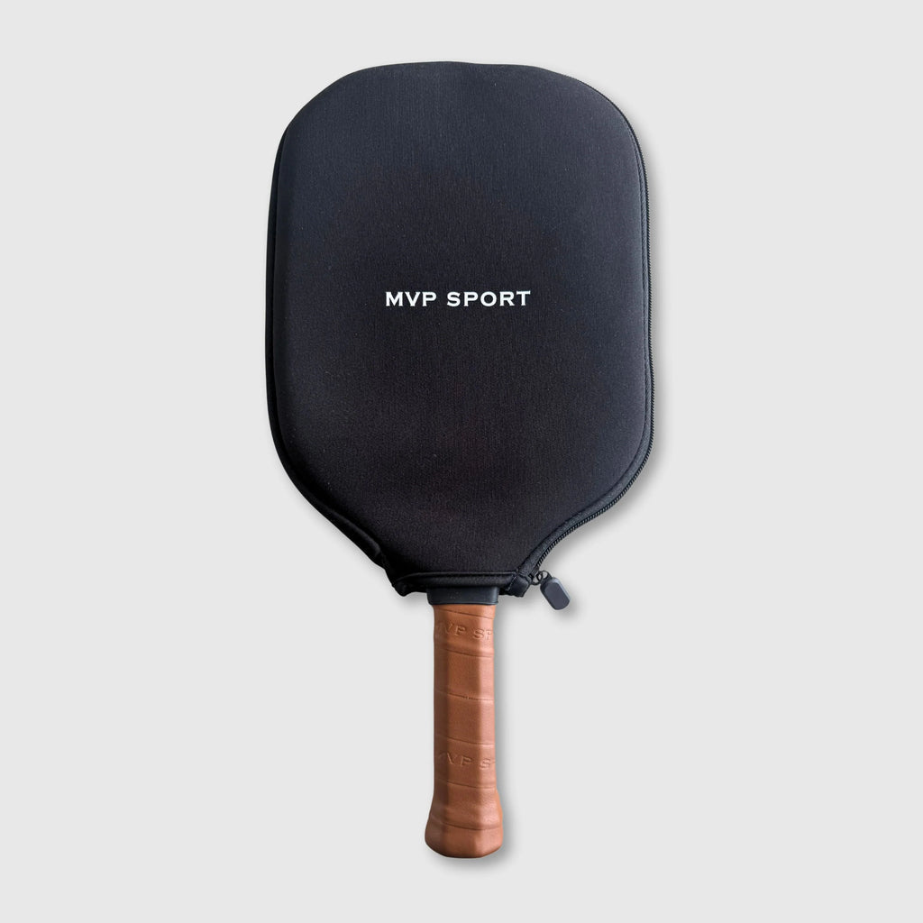 Black pickleball paddle with wooden handle on a light gray background
