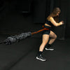 Person using resistance bands for exercise on a dark background