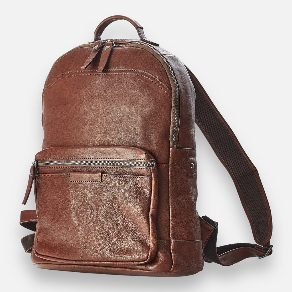 A brown leather backpack with a front pocket and visible zipper closure. The backpack features an embossed design on the front pocket.