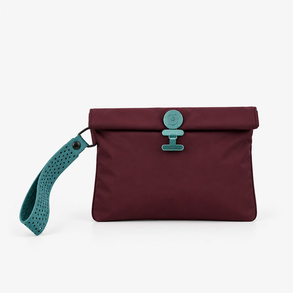 Burgundy La Pochette sweat bag with teal closure and perforated wrist strap on grey background.