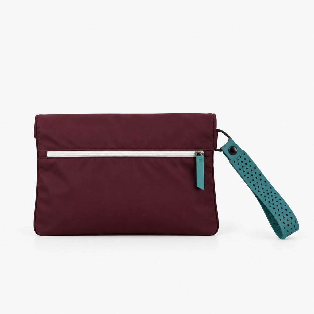 A burgundy nylon clutch pouch with a horizontal silver zipper, a teal zipper pull, and a matching teal perforated wrist strap, shown on a plain white background.