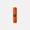 Orange fitness band on a light gray background