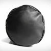 Black leather detail of a leather punching bag on a white background