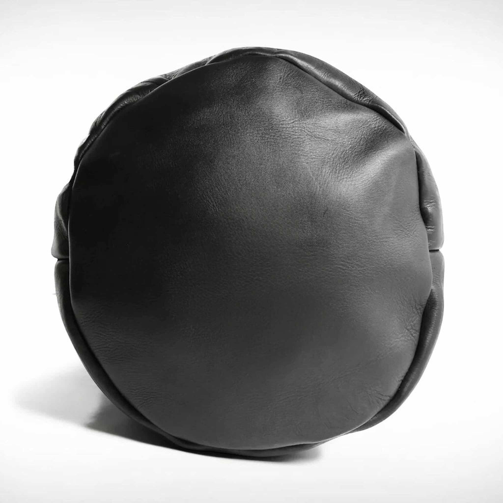 Black leather detail of a leather punching bag on a white background