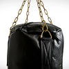 Black punching bag with gold chains on a white background