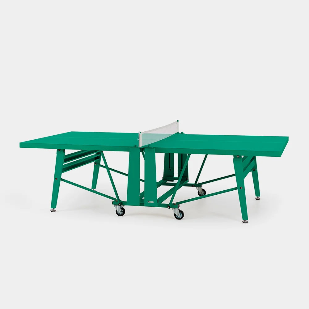 Green ping pong table with a white net on a white background