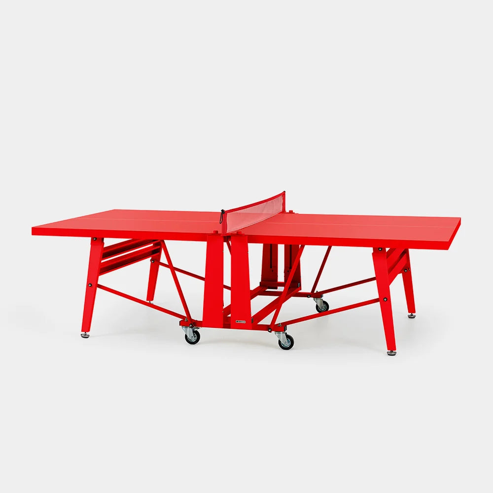 Red folding ping pong table on grey background