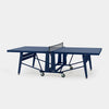 Blue folding ping pong table on grey background