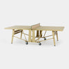 A light wood and gold-finished folding table with a net on wheels, shown on a clean white background.
