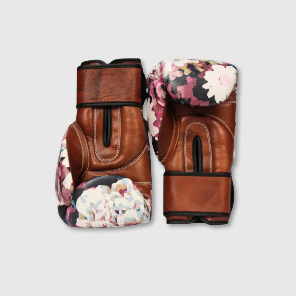 Pair of brown boxing gloves with floral pattern on a light gray background