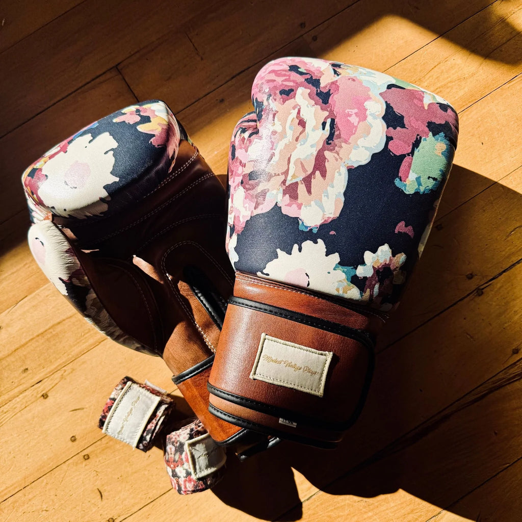 Floral boxing gloves on a wooden floor
