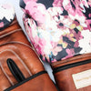 Pair of brown leather shoes with floral patterned insole on a white background